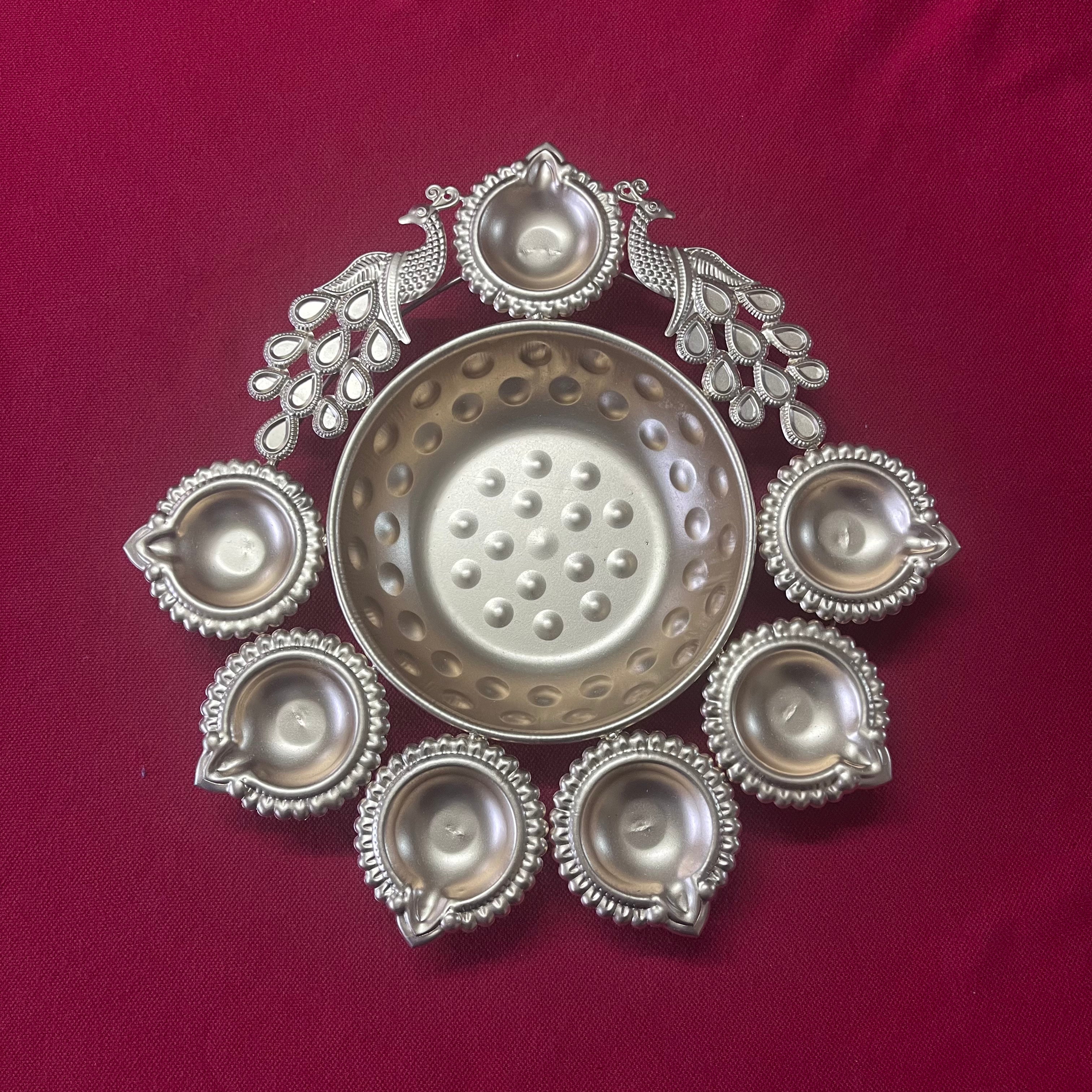 Urli with Diya and Peacock Figurines