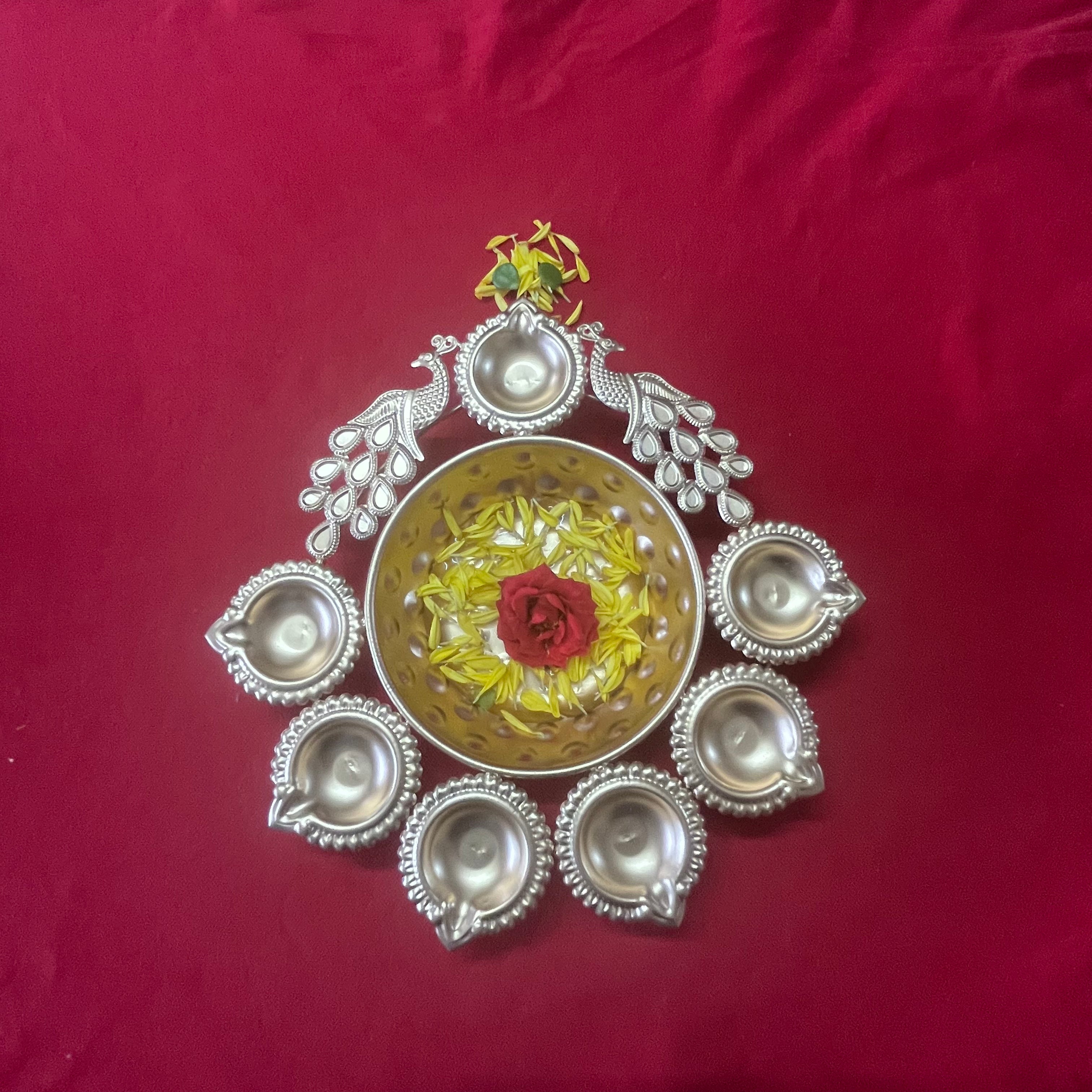 Urli with Diya and Peacock Figurines