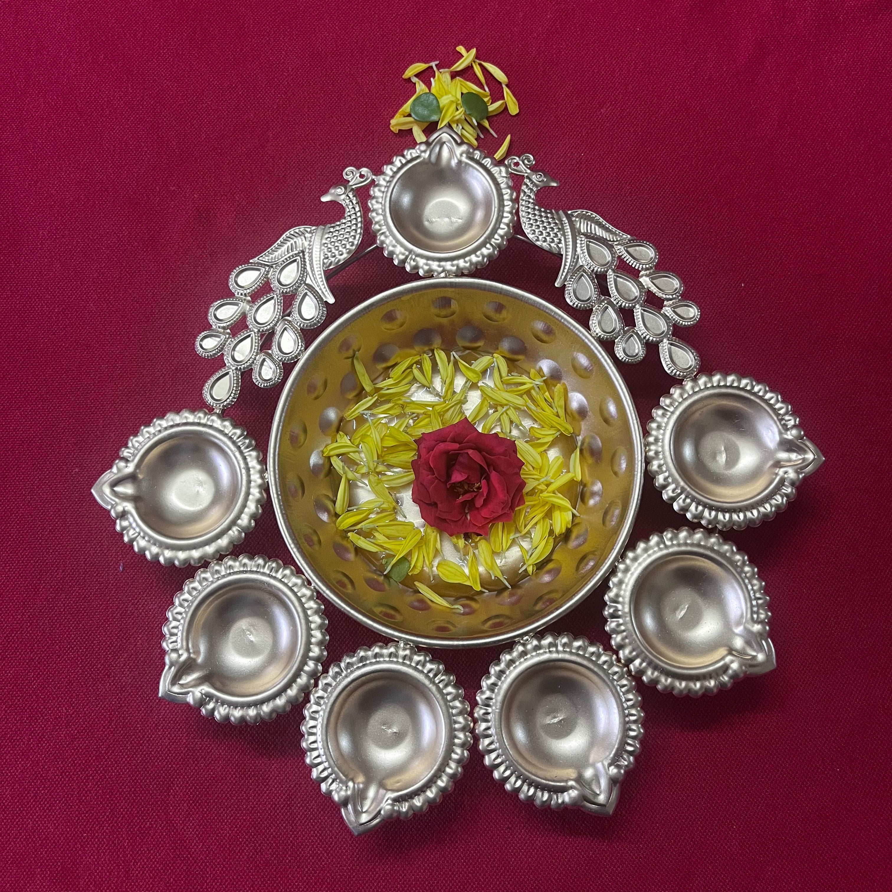 Urli with Diya and Peacock Figurines