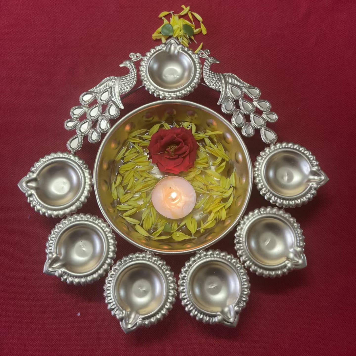 Urli with Diya and Peacock Figurines